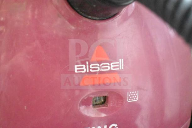 Bissell 4122 Zing Vacuum Cleaner with logo; maroon surface showing signs of wear. 120 Volts, 1 Phase.