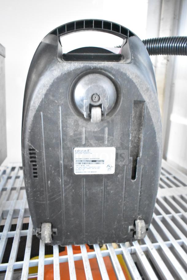 Bissell 4122 Zing Vacuum Cleaner, 120V, visible wear, model label on back, black casing, compact design.