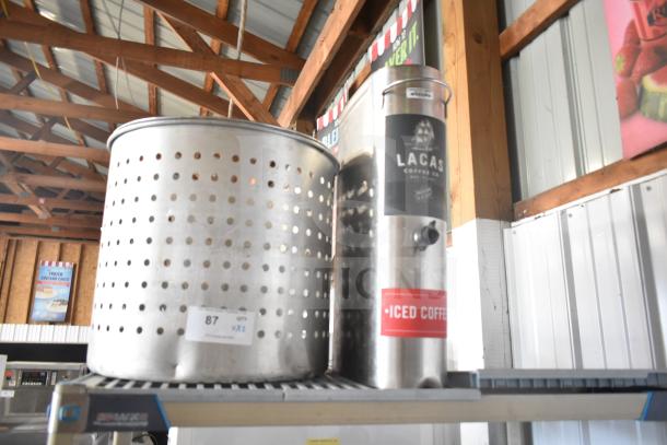 Stainless steel steamer pot insert and Lacas iced coffee beverage dispenser, both in good condition on a metal shelf.