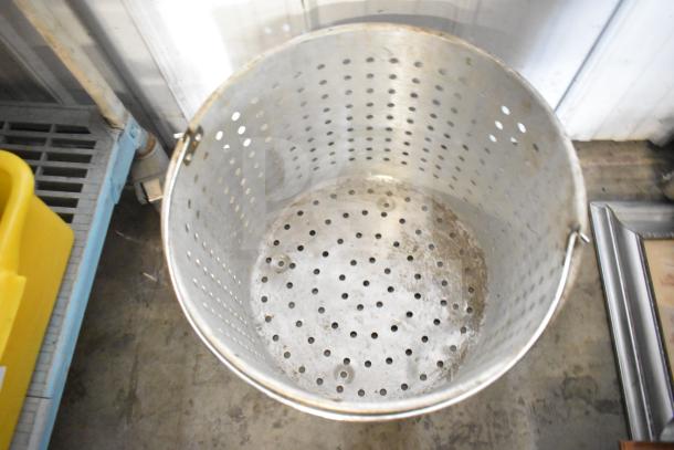 Stainless steel steamer pot insert with perforations, handle, and used condition. Suitable for steaming food.