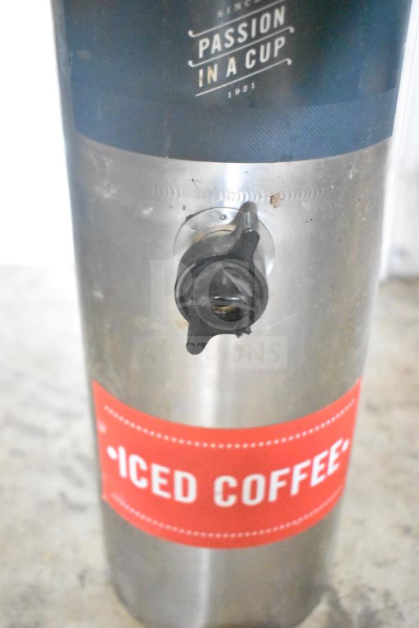 Stainless steel beverage holder dispenser with "Passion in a Cup" branding and "Iced Coffee" label. Faucet visible.