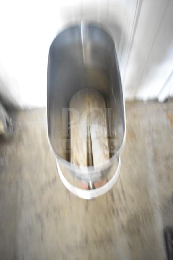 Blurred image of a metal steamer pot insert with visible handles. Condition appears used. Other item not visible.