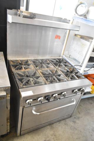 Commercial gas-powered 6 burner range with oven, over-shelf, and back splash. Stainless steel, used condition.