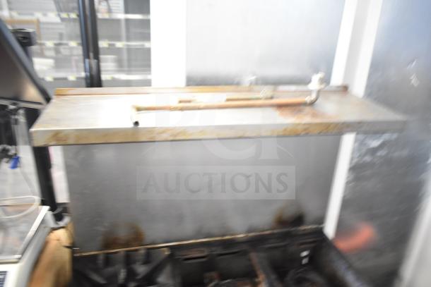 Garland Commercial 6 Burner Range with oven, over shelf, and back splash; visibly used condition.