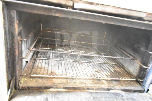 Garland Commercial 6 Burner Range Oven interior, used, with racks visible. Oven shows signs of wear.