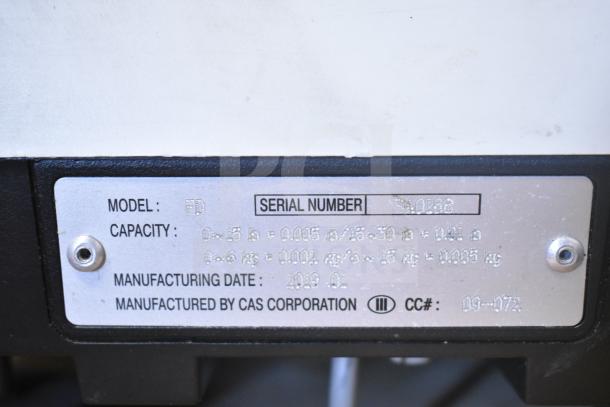 "CAS ED scale label with model, serial number, capacity, and manufacturing date details visible."