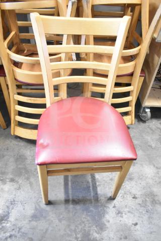 Wooden dining chair with maroon seat cushion, ladder-back design. Some wear visible. Auction for 10 chairs.