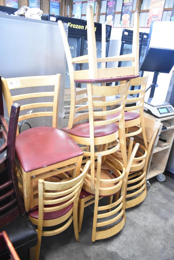 10 wooden dining chairs with maroon seat cushions, stackable, used, natural finish. Auction quantity: 10 times bid.
