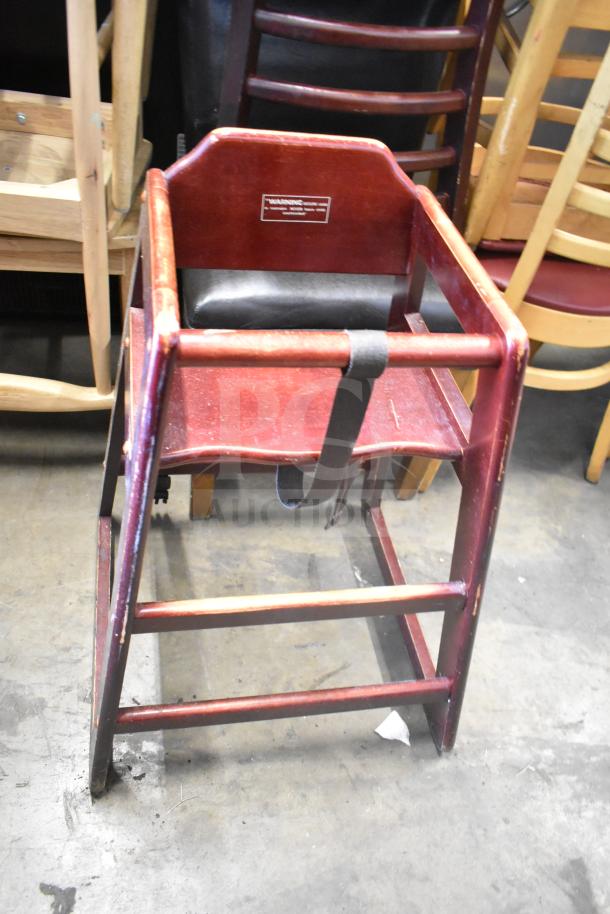 Wooden high chair with safety strap, vintage finish, visible wear. Includes warning label on back. Part of 7-item lot.