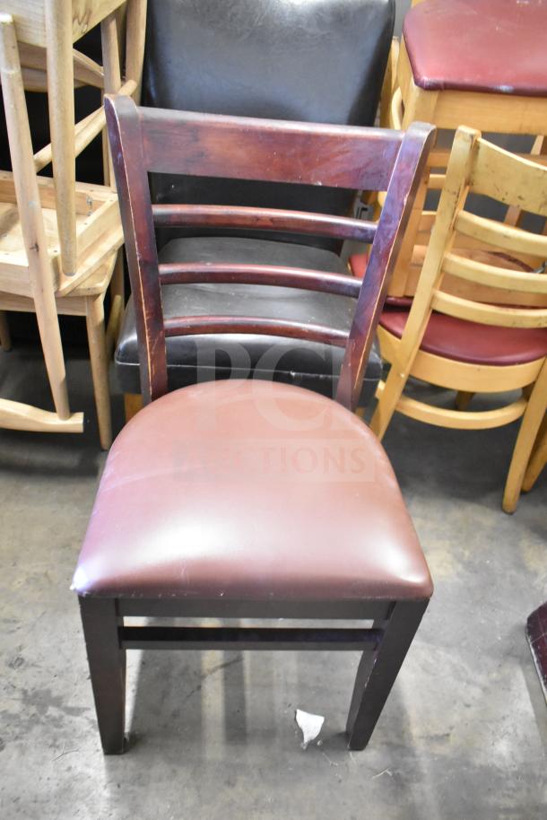 Seven assorted chairs including a high chair and dining chairs, featuring wood frames and varying upholstery. Used condition.