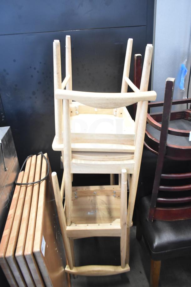Stacked wooden high chairs and dining height chairs, auction includes 7 furniture items. Chairs appear in good condition.