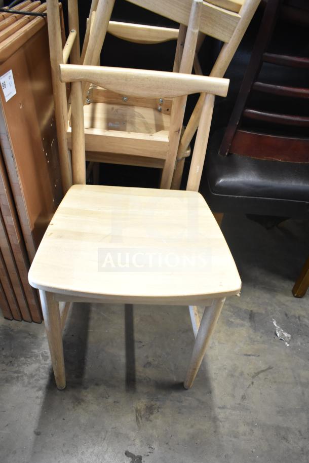 Set of 7 wooden chairs including dining-height and high chair. Features light finish, sturdy build. Auction lot conditions vary.