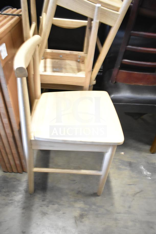 Wooden dining chairs and high chair set, light wood finish, stackable design, moderate wear, suitable for dining or kitchen use.