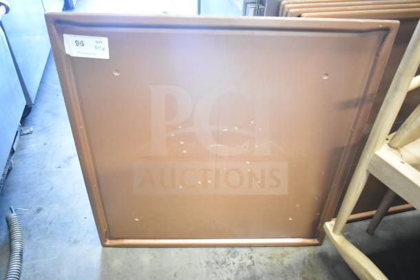Five rectangular brown tabletops in used condition, visible auction tag marked "96 QTY x5."