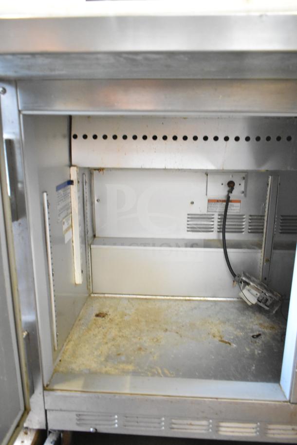 Beverage Air SP48-12C Sandwich Prep Table, commercial grade, stainless steel, visible wear, requires cleaning. 115V, 1 Phase.