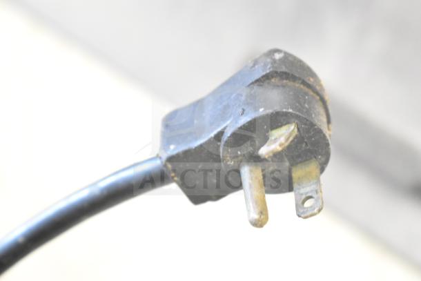 Close-up of a standard three-prong plug for Beverage Air SP48-12C prep table, showing some wear and discoloration.