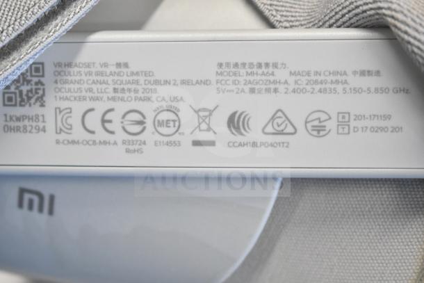 Oculus MH-A64 VR headset label with model info, certification marks, and manufacturer details visible.