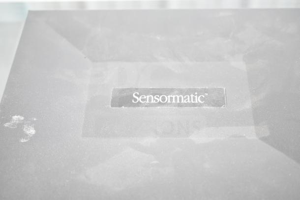 Sensormatic AMB-9010-IPS Label Deactivator, gray with visible logo, slight surface wear, valuable retail security device.