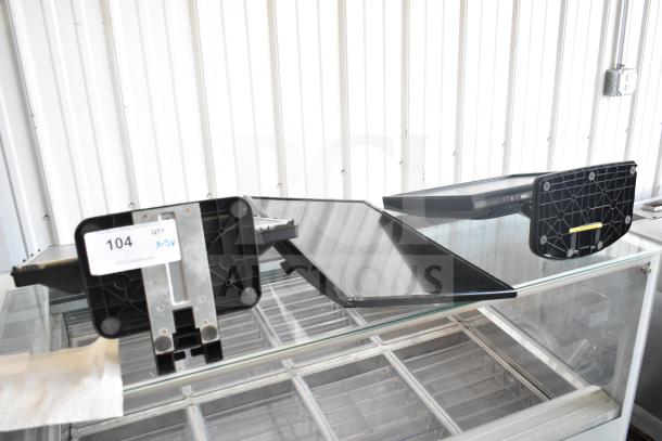 Three computer monitors including Dell, Onn 100002480 22", HP L1710 17", shown on a glass surface with tags marked "104".