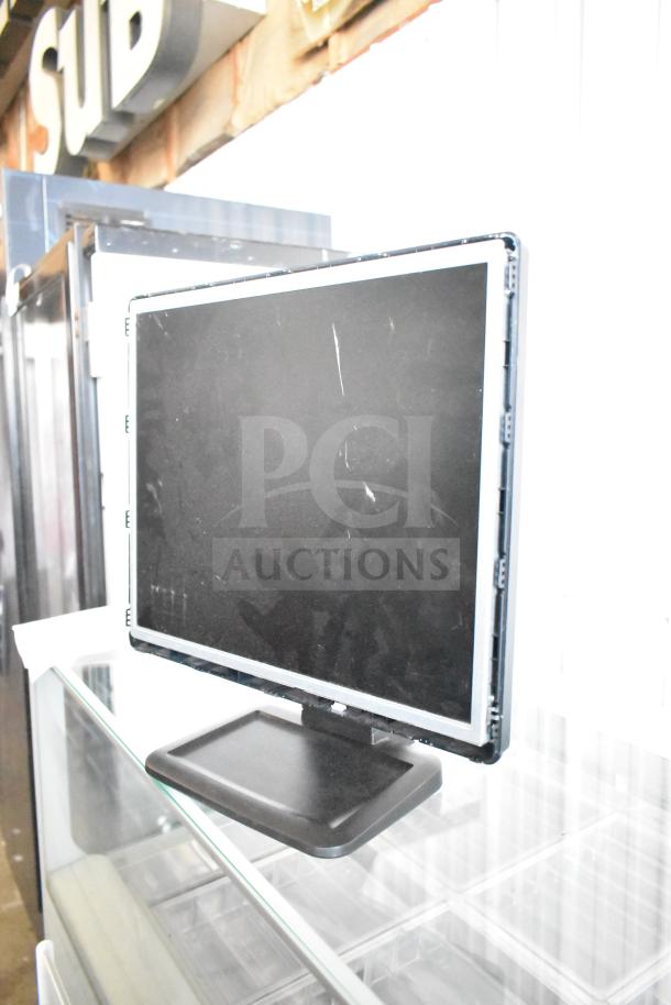 Three computer monitors, including Dell, Onn 100002480 22", and HP L1710 17". Scratches visible on screens.