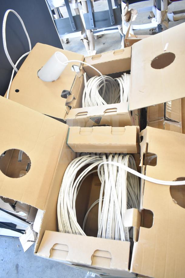Four boxes of white cable in cardboard boxes, new condition, with lengths coiled neatly. Ideal for bulk purchase.