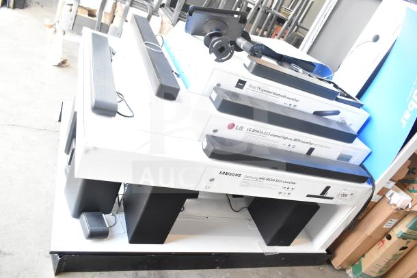 Speaker store display with Samsung, LG, Bose, Hisense, TCL, Vizio sound bars. Includes boxes with brand labels.