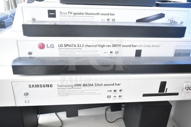 Speaker store display with Samsung HW-B63M, LG SPM7A, and Bose sound bars. Features include Dolby Atmos and Bluetooth.