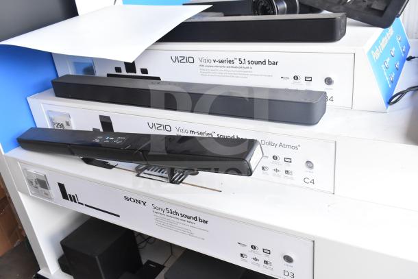 Speaker store display with Samsung, LG, Bose, Hisense, TCL, Vizio sound bars. Includes Vizio m-series and Sony 5.1ch sound bar labels.