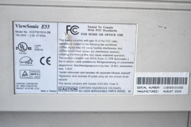 Two ViewSonic E55 monitors, model VCDTS21914-2M, 15", 100-240V. Includes labels showing compliance and serial number.