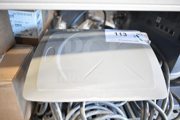 Sensormatic ZBSMPCPEF Compact Pad Pro, in good condition with visible PCI Auctions label and accompanying cables.