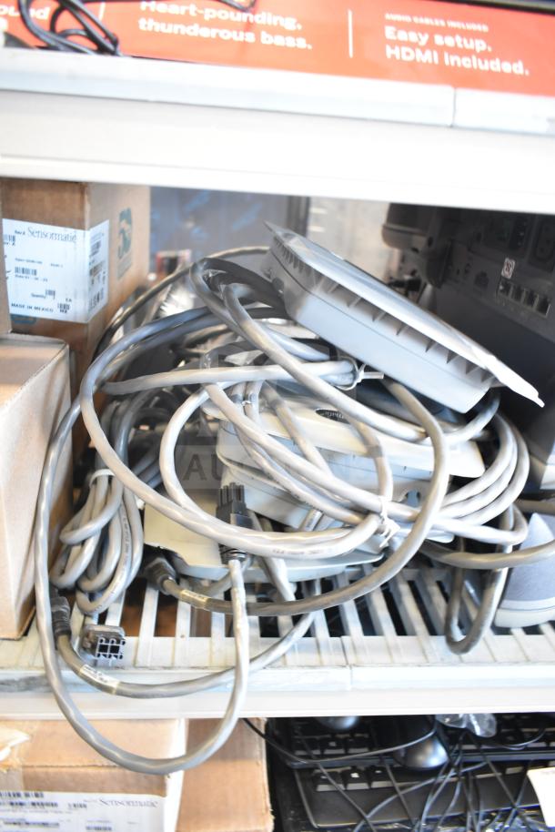 8 Sensormatic ZBSMPCPEF Compact Pad Pro units with tangled cables. Includes original labeled boxes. Suitable for security systems.