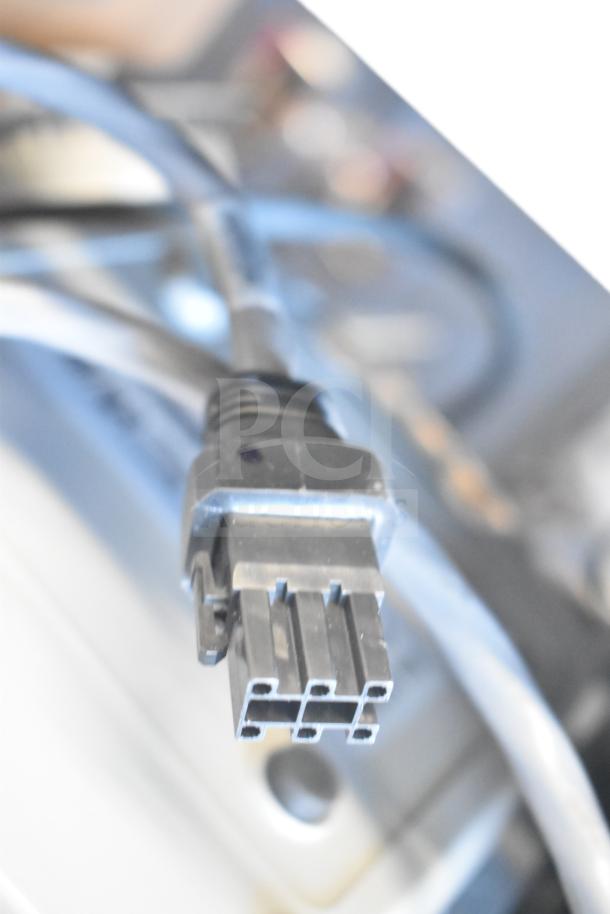 Close-up of Sensormatic ZBSMPCPEF Compact Pad Pro connector, featuring black plastic housing and multiple ports.