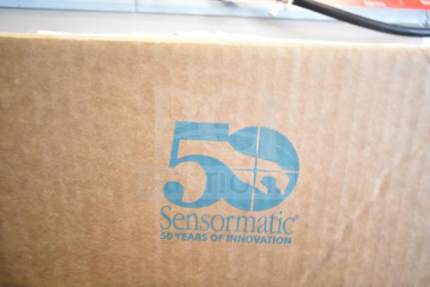 Cardboard box featuring Sensormatic branding and "50 Years of Innovation" text. Part of a 12-item auction.