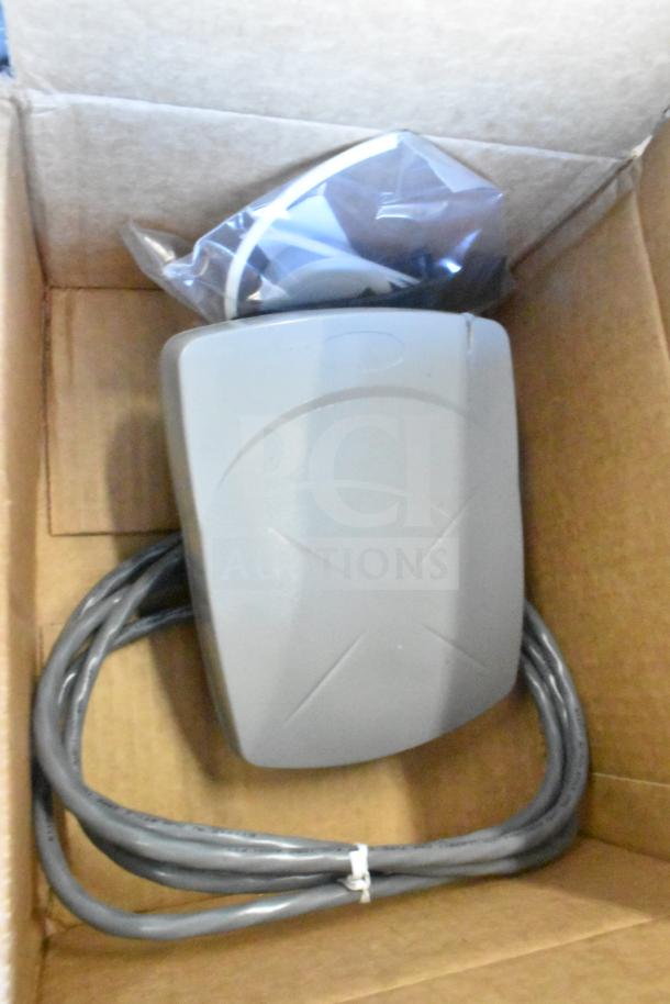 Sensormatic ZBAMB9012 Label Deactivator Antenna in box with cable, part of a 12-item auction lot.