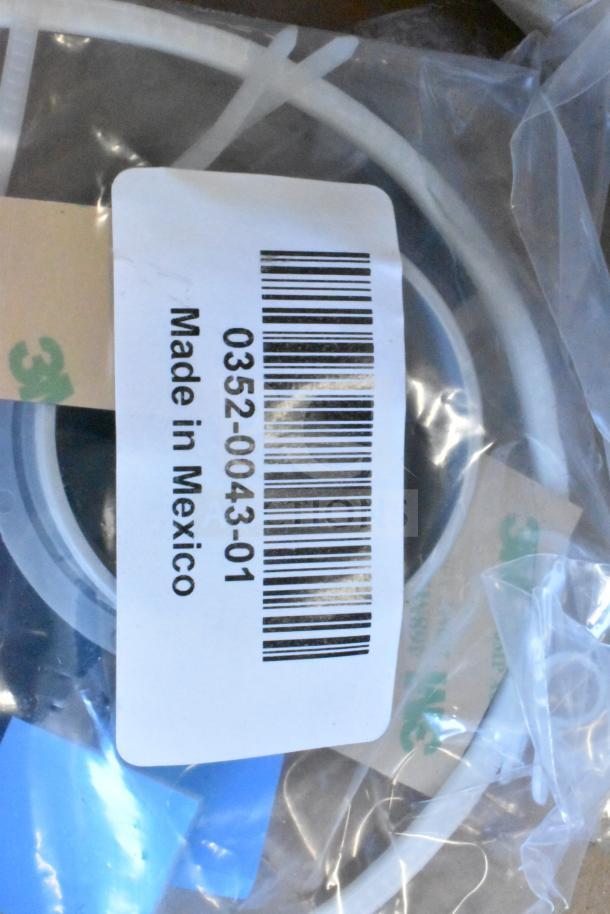 Bagged item with label "0352-0043-01 Made in Mexico," featuring white cables. Part of a 12-item auction lot.