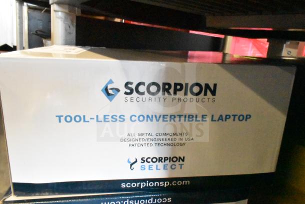 Box of Scorpion 720029-B Tool Less Convertible Laptop Security Device. All metal, USA-made, patented technology.