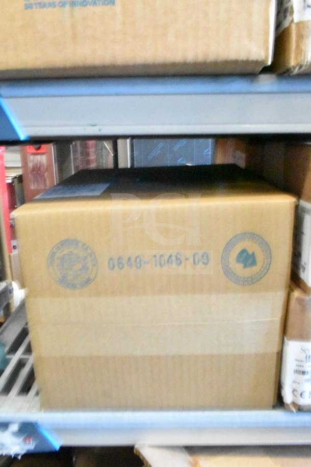 Cardboard box with markings, containing Sensormatic ZBAMB9010-IPS Deactivator items. Box ID: 0649-1046-09. Stored on shelf.