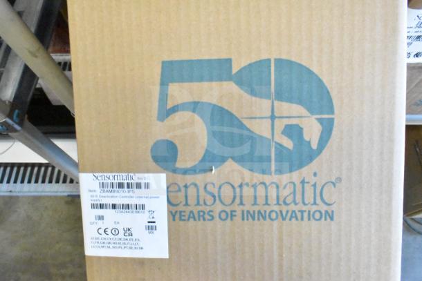 Sensormatic Deactivator Controller ZBAMB9010-IPS in box, packaging includes labels detailing model and region certifications.