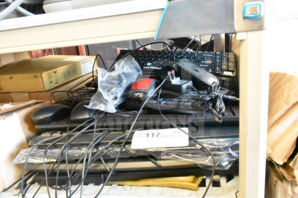 Lot of various electronic items including a Logitech computer mouse and multiple keyboards. Mixed condition. Tag marked "117".