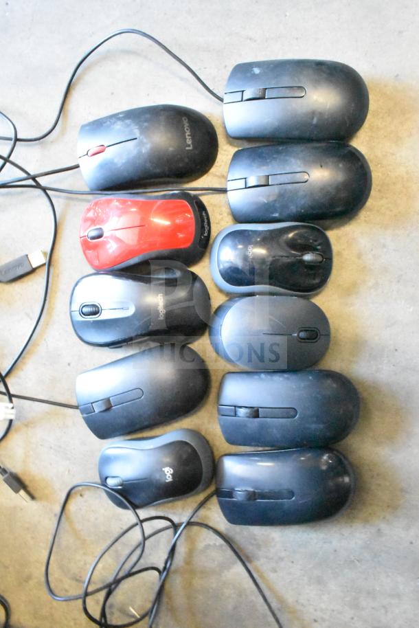 Lot of various computer mice, including Logitech and Lenovo brands, some wired, visible wear.