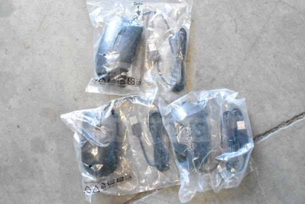 Auction lot featuring various computer items, including multiple USB-cabled computer mice, all sealed in clear packaging.