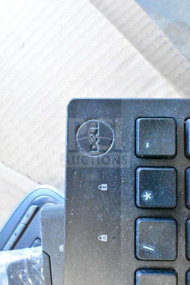 Dell keyboard with visible logo, part of a lot. Includes various items like a computer mouse. Condition appears used.