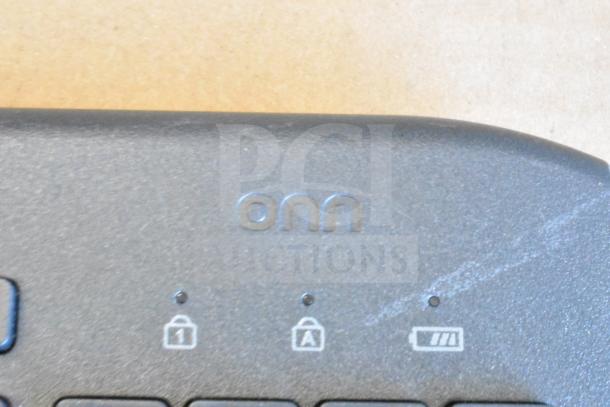 ONN keyboard corner with lock and battery indicators. Part of a lot with various items, including a mouse.