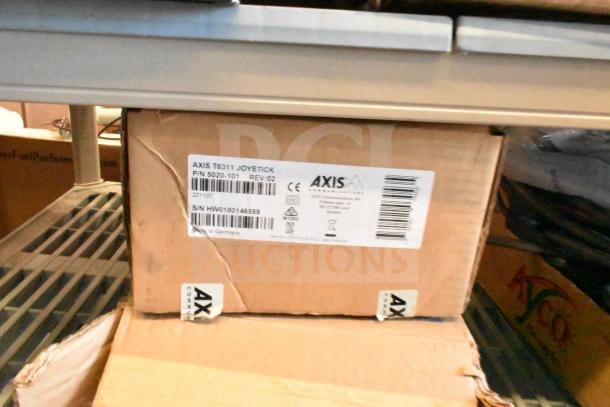 Box of Axis T8311 Joystick, Part No. 5020-101, S/N HW0180146559, on shelf. Label details model and certification.