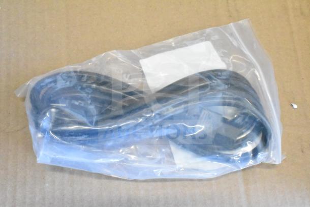 Plastic bag containing a coiled cable, possibly Sensormatic, in used condition. Transparent packaging shows item inside.
