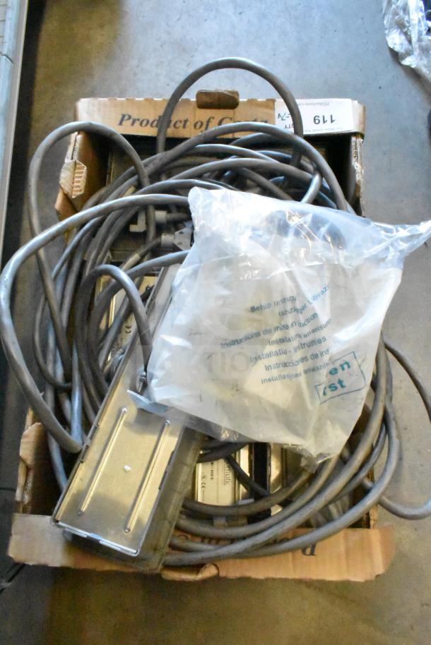 Box of 7 items including various cables and a Sensormatic ZBSTPSP-L unit, coiled and packaged in a cardboard box.