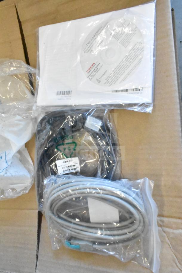 Seven various items including cables and a Sensormatic ZBSTPSP-L unit in original packaging, featuring labeled tags.