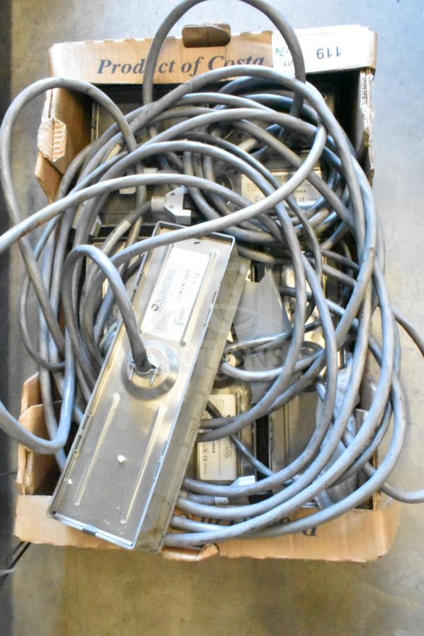 Box of 7 items including cables and a Sensormatic ZBSTPSP-L unit, visibly used, tangled, and labeled for auction.