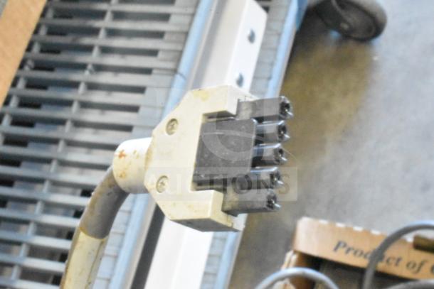 Close-up of various cables, featuring a connector. Includes Sensormatic ZBSTPSP-L unit. Condition appears used.