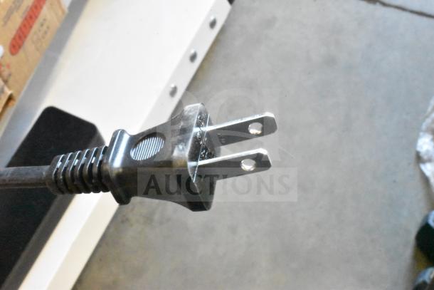 Power plug of a Bose Sound Bar, showing its standard two-prong design.